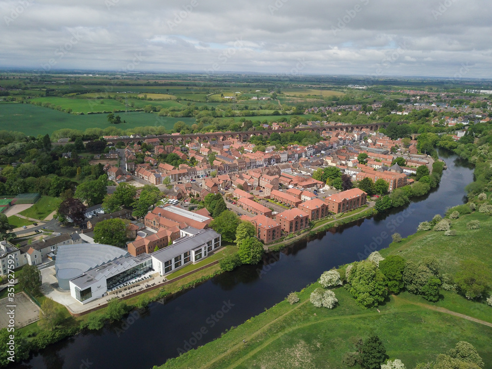 The historic market town of Yarm in North Yorkshire from above by drone showing the River Tees
