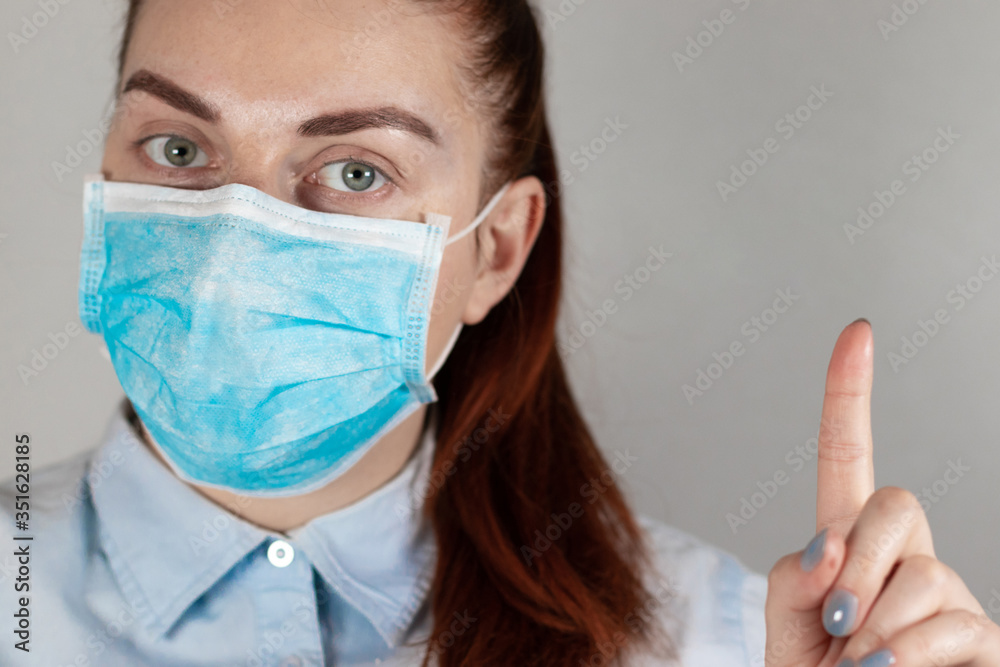 Girl in medical mask on grey background. Protection against diseases, epidemics and viruses. Coronavirus, covid 19 Girl in medical mask on grey background. Protection against diseases, epidemics and viruses. Coronavirus, covid 19