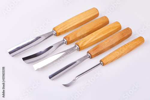  Set of wooden chisels for carving wood, sculpturing tools on white background. 