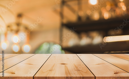 Empty old wood table top with bokeh coffee shop interior background