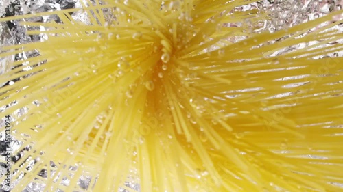 Spaghetti throwing into the water. Pasta falling into boiled water. Look up view. Slow motion.
