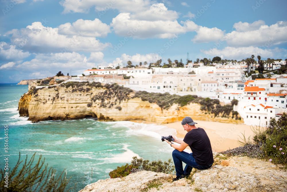 A man taking photo of beautiful holiday destination by Atlantic ocean, Carvoeiro, Portugal