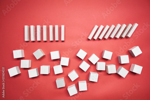 Business risk management concepts. Wooden block stop falling of other pieces of domino effect.