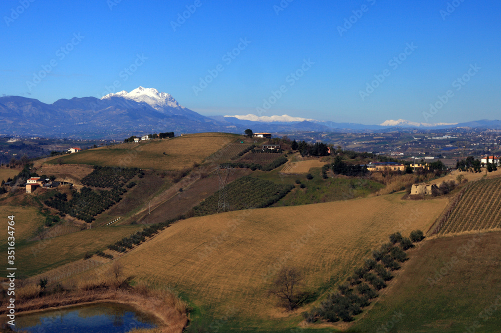 typical Abruzzo landscape with hills and cultivated fields and Mount Gran Sasso. Chieti, Italy.