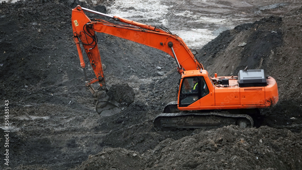 Tractors and excavators work on the construction of the foundation zero cycle Tractors and excavators work on the construction of the foundation zero cycle