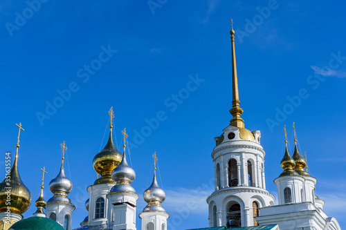 golden metal domes of an Orthodox church and the spire of a bell tower