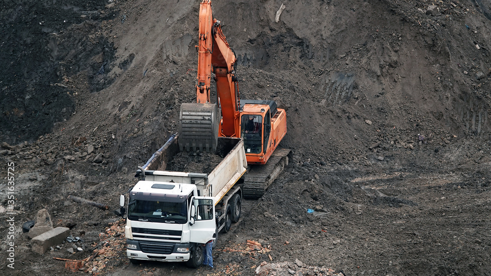 Tractors and excavators work on the construction of the foundation zero cycle Tractors and excavators work on the construction of the foundation zero cycle