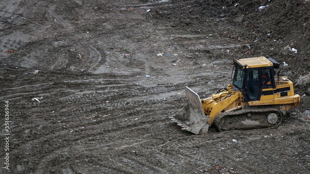 Tractors and excavators work on the construction of the foundation zero cycle Tractors and excavators work on the construction of the foundation zero cycle