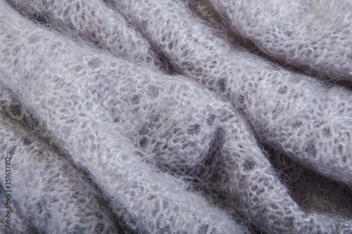 top view macro folded openwork binding gray, knitted, woolen shawl with pattern