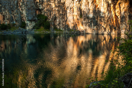 Beautiful lake between the rocks. The rocks are reflected in the water. Ansiao- Portugal