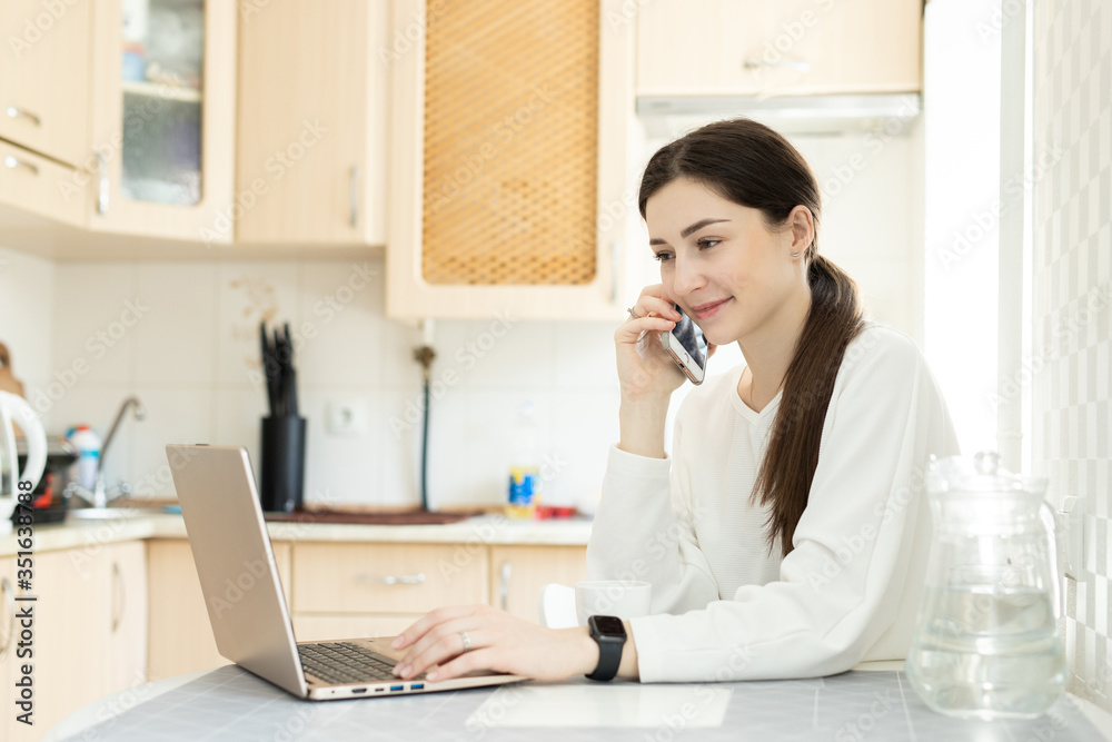 The young girl remote work and consults by telephone from home The young girl remote work and consults by telephone from home