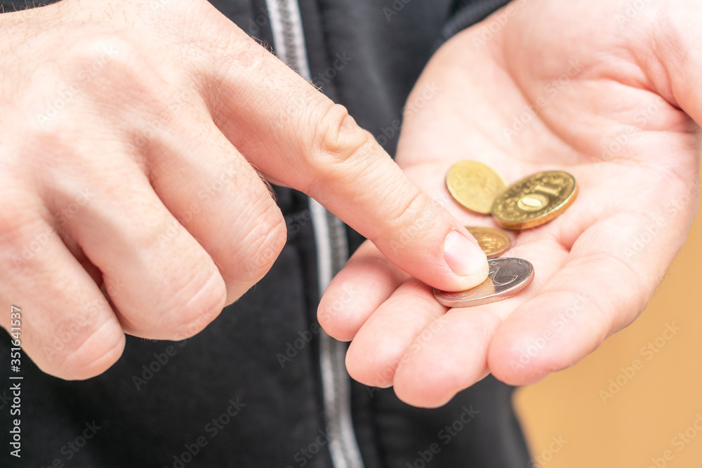  Man with coins, close up, cropped image, poverty concept