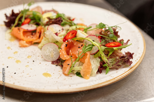 Simple salad with lettuce and salted salmon