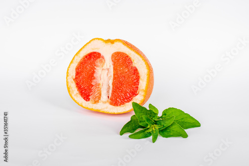 Fototapeta Naklejka Na Ścianę i Meble -  Fresh juicy grapefruits with green leafs isolated on white background