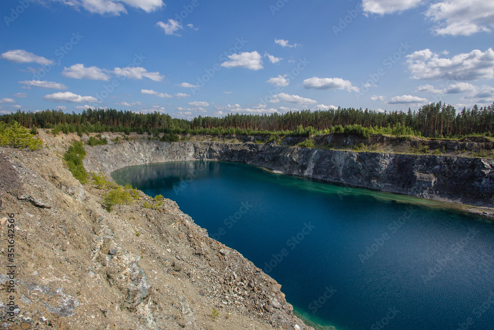Flooded open pit chromium chrome ore quarry mine with blue water