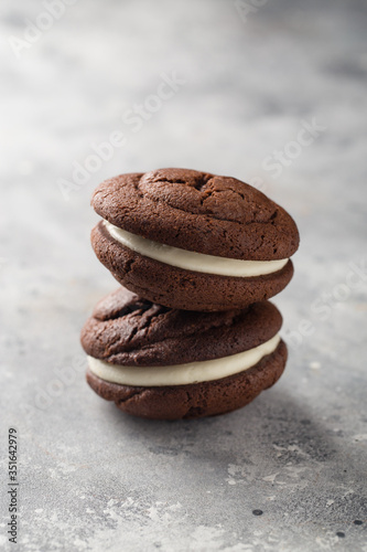 Chocolate whoopie pies on gray stone background
