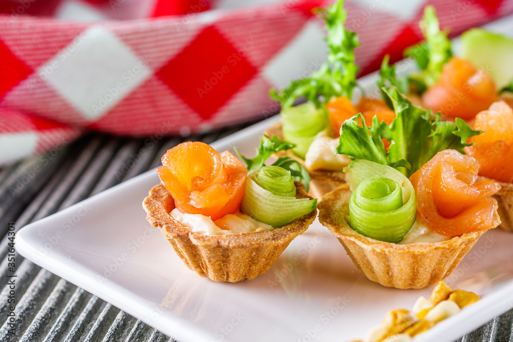 delicious snack tartlets on rustic wooden background delicious snack tartlets on rustic wooden background