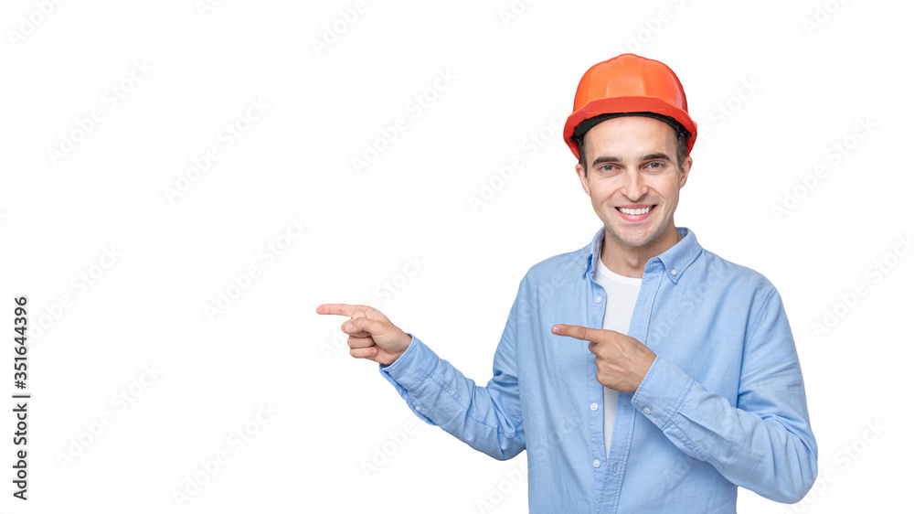Cheerful builder in helmet shows copy space, isolated background, 16:9 Cheerful builder in helmet shows copy space, isolated background, 16:9