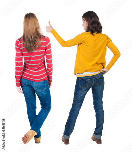Back view of couple in sweater showing thumbs up.