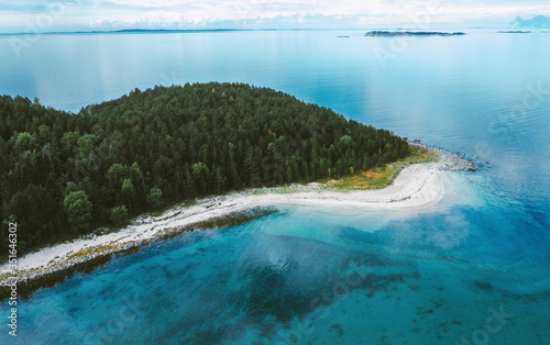 Island aerial view drone above ocean and coniferous forest trees landscape in Norway blue sea water scandinavian nature wilderness scenery