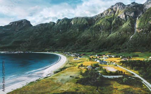 Aerial drone view above Storvika beach and ocean with mountains above village landscape travel rural scenery in Norway photo