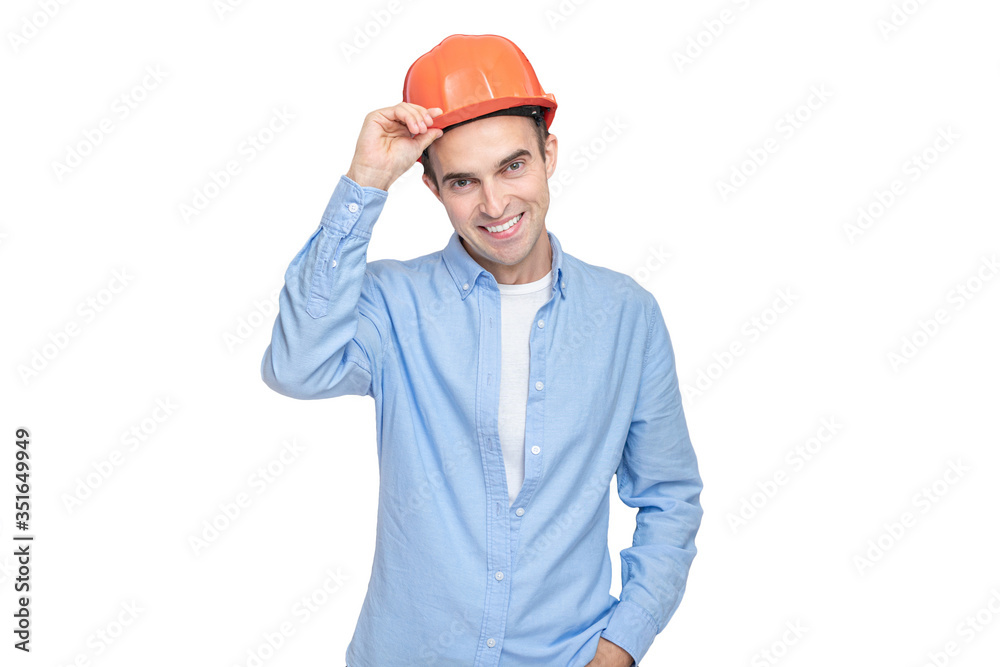 Constructor takes off his helmet and looks at the camera, isolated background, copy space