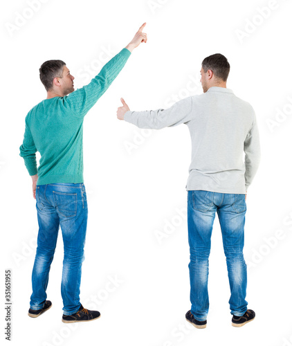 Back view of two man in sweater pointing.