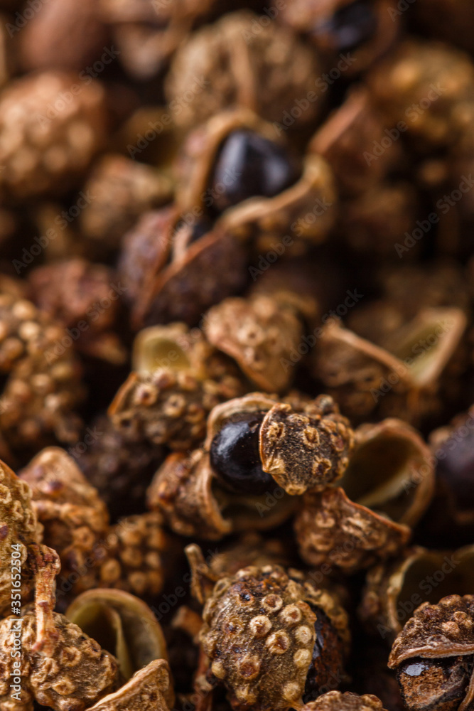 Obraz premium fragrant Sichuan pepper on white acrylic background