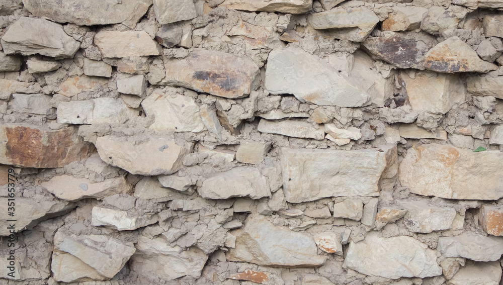 Texture of an old stone wall closeup as background. Antique flat stone natural wall Texture of an old stone wall closeup as background. Antique flat stone natural wall