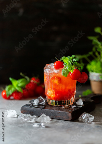 Ice tomato juice in a glass goblet.