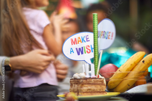 Slice of  birthday cake on  party with  sign accessory make a wish