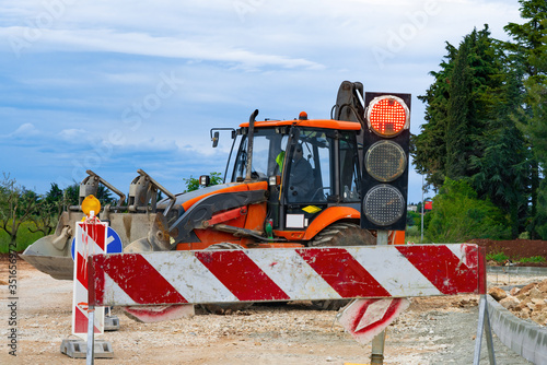 Barrier at a road construction site. The construction site is protected by warning signs.