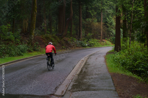 person riding a bike in Stanley Park Vancouver