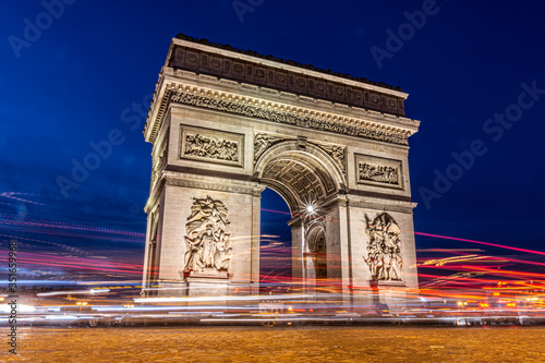 Paris triumphal arch at night, it is a long exposure in the blue hour with the traces of the lights of the cars © Adolf