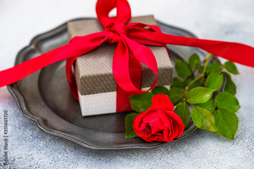 Table setting with red rose