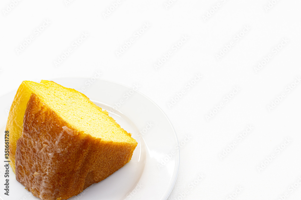 Closeup piece of sweet lemon cake served on white plate,Copy space. Closeup piece of sweet lemon cake served on white plate,Copy space.