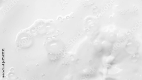 Pouring fresh milk in slow motion. A stream of milk pours down creating splashes and waves. Close-up pouring milk in Slow Motion with crown splash.