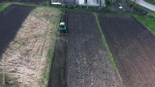 top view, aerial view. the tractor cultivates the land. preparation for growing crops. agriculture in the village and in the countryside.