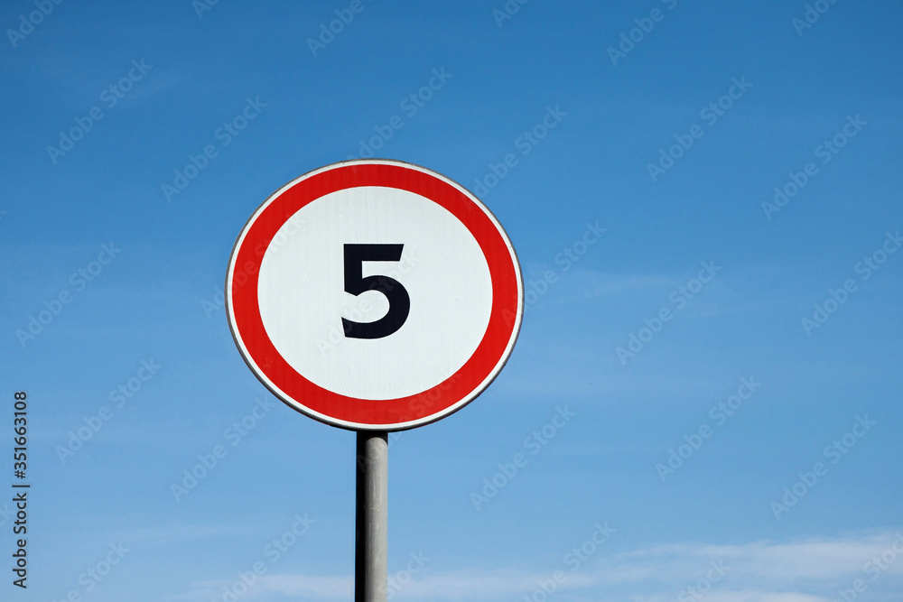 International traffic sign 'Speed limit' (to 5 km per hour). Blue sky is on background International traffic sign 'Speed limit' (to 5 km per hour). Blue sky is on background