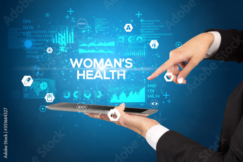 Close-up of a touchscreen with WOMAN’S HEALTH inscription, medical concept