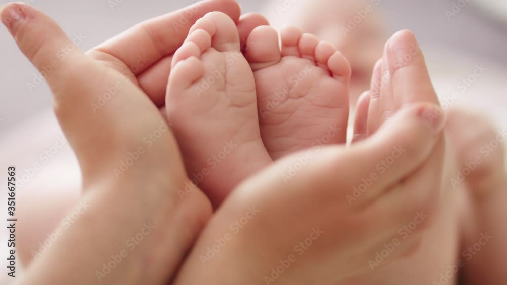 Baby feet in mothers hands. Close up. Happy Family concept. Baby feet in mothers hands. Close up. Happy Family concept.