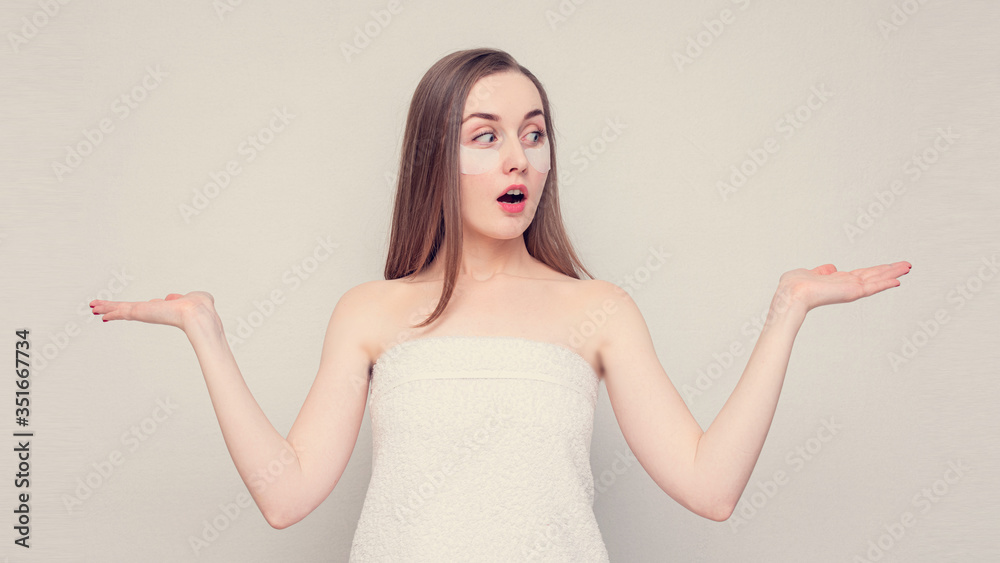 Amazed girl shows palms free space for advertising, empty space, portrait, white background, 16:9 Amazed girl shows palms free space for advertising, empty space, portrait, white background, 16:9