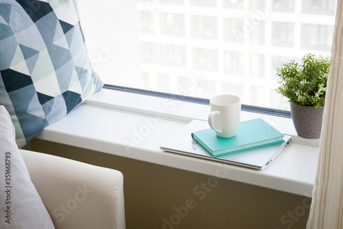  white mug  blue diary and notebook. light working morning