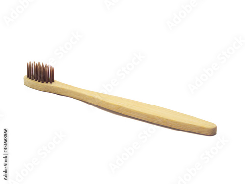 wooden toothbrush with brown pile on a white background isolated