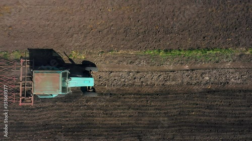 top view, aerial view. the tractor cultivates the land. preparation for growing crops. agriculture in the village and in the countryside.