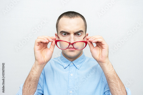 Teacher man takes off his glasses  man has poor eyesight  portrait  white background