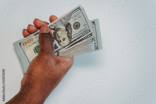 african american man with a stack of US one hundred dollar bills in his hands