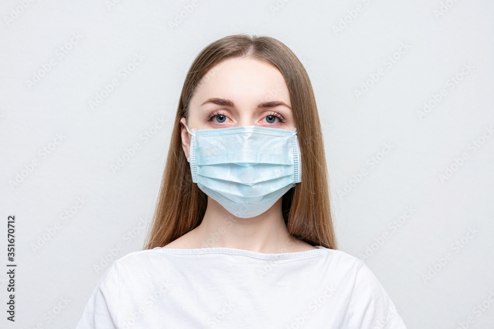 Young girl in medical mask because of air, white background, copy space Young girl in medical mask because of air, white background, copy space