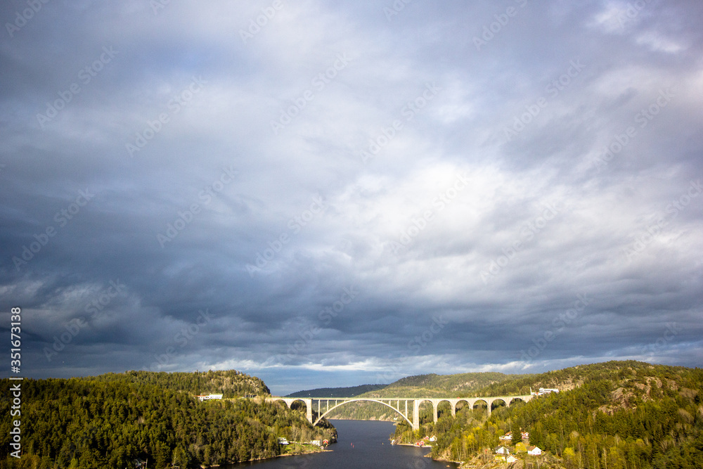 Slow river with dramatic clouds and trees around Slow river with dramatic clouds and trees around