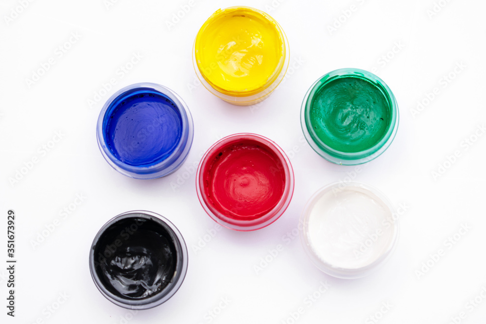 Cans of different colors gouache paints, top view, closeup, white background Cans of different colors gouache paints, top view, closeup, white background